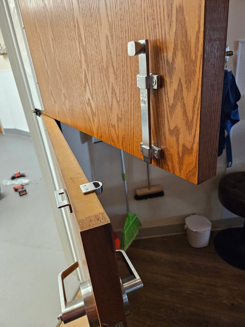 Ives flush bolt installed on the inactive leaf of a wood double door, with the strike on the frame