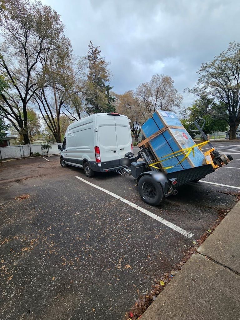 Duboff Locksmith service van towing a safe-moving trailer with a crated safe strapped upright