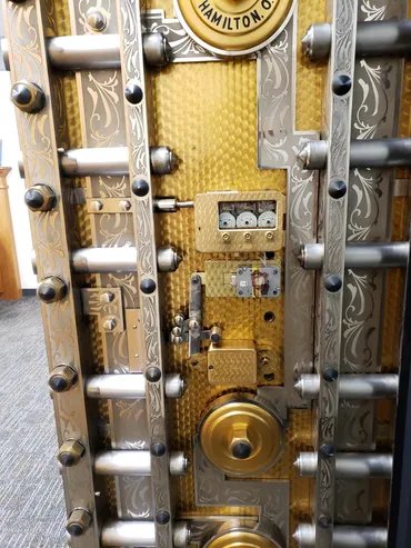 Engraved brass bank vault door with time locks